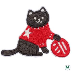 Black embroidered cat wearing red sweater holding red ball patch