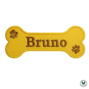 Yellow bone-shaped embroidered patch with brown text Bruno and paw prints