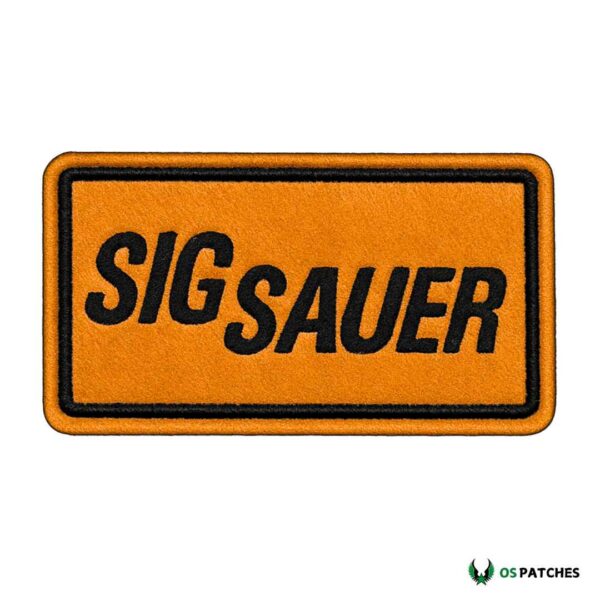 Rectangular orange leather patch with embroidered black SIG SAUER text logo.