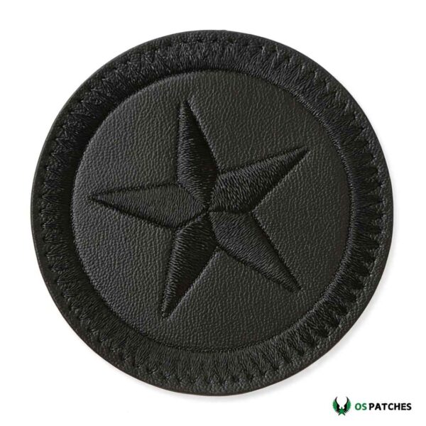 Round black leather patch with embroidered five-point star design.