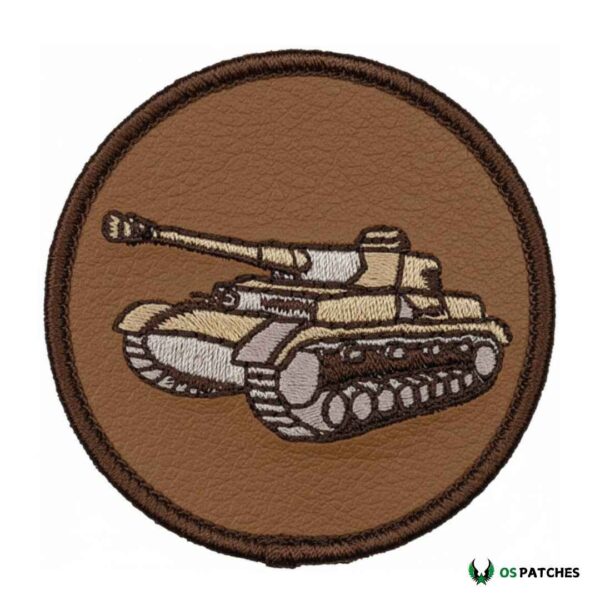 Round brown leather embroidered patch with a tank design in beige, grey, and dark brown.