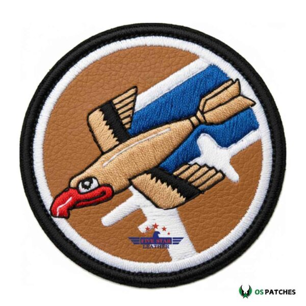 Round brown leather embroidered patch with a flying bird and airplane design.