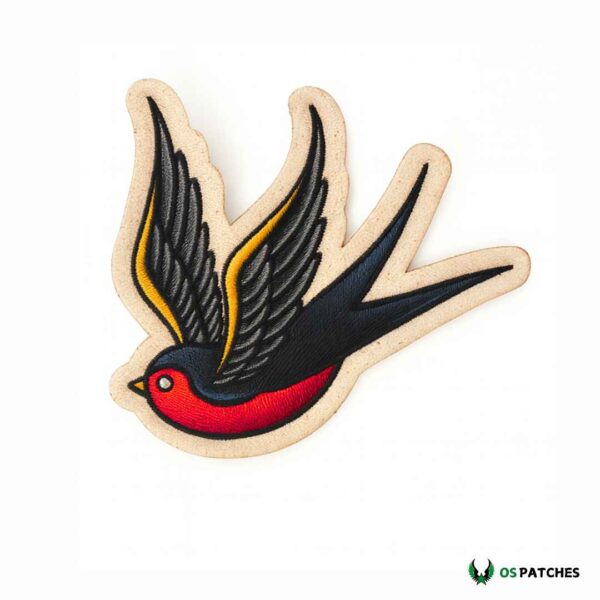Printed leather patch with flying swallow bird in black, red, and yellow colors