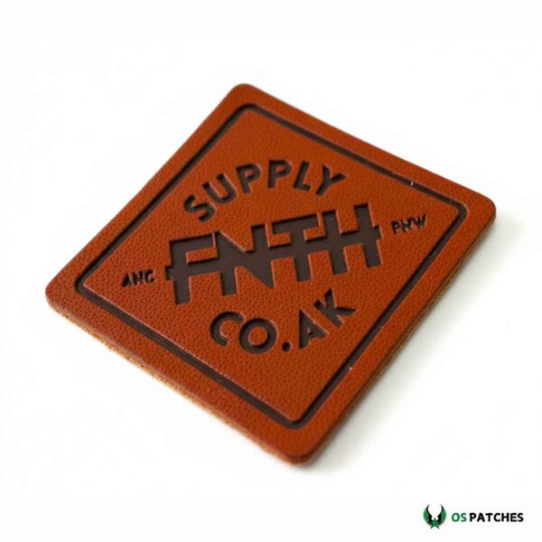 Square brown leather patch engraved with FNTH Supply Co. UK logo
