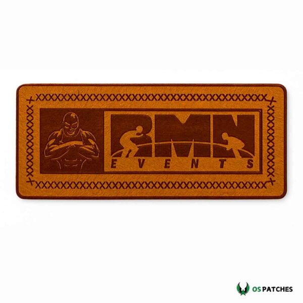 Rectangular brown leather patch engraved with RMN Events wrestling design
