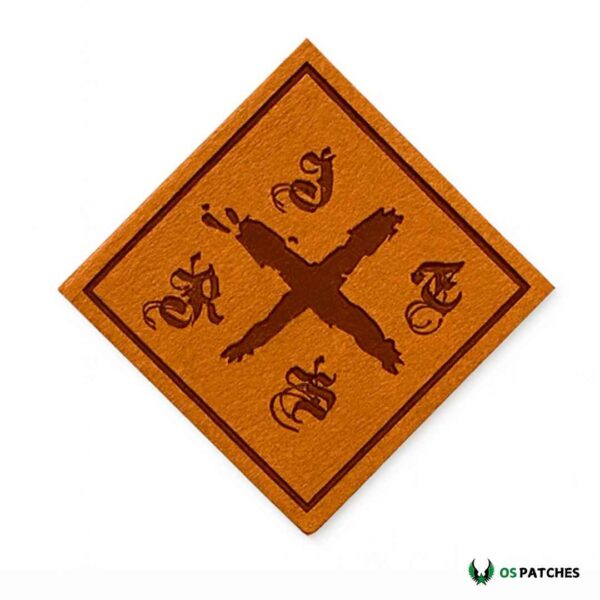 Diamond-shaped brown leather patch engraved with gothic letters and bold X symbol