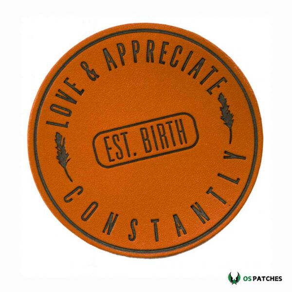 Round brown leather patch engraved with text Love & Appreciate Constantly Est. Birth