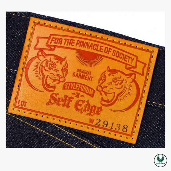 Self Edge leather patch with tiger design on denim jeans